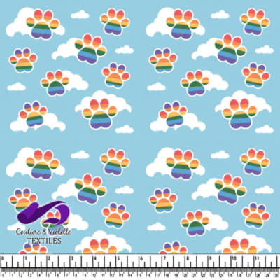 Rainbow striped paw prints among white clouds on a blue sky